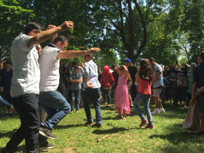 Syrian Newcomers dancing at a picnic